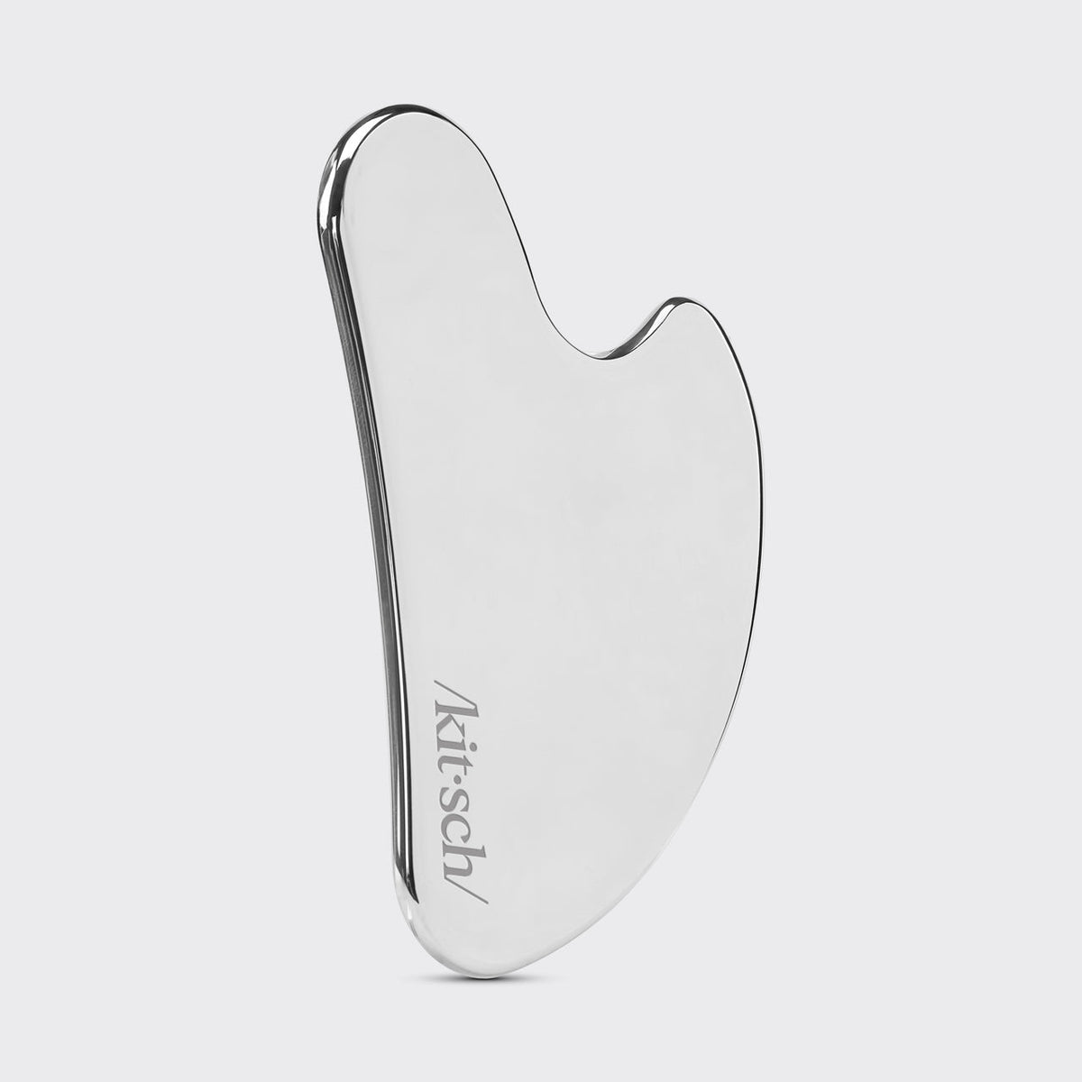 Using the Kitsch Stainless Steel Gua Sha along the jawline